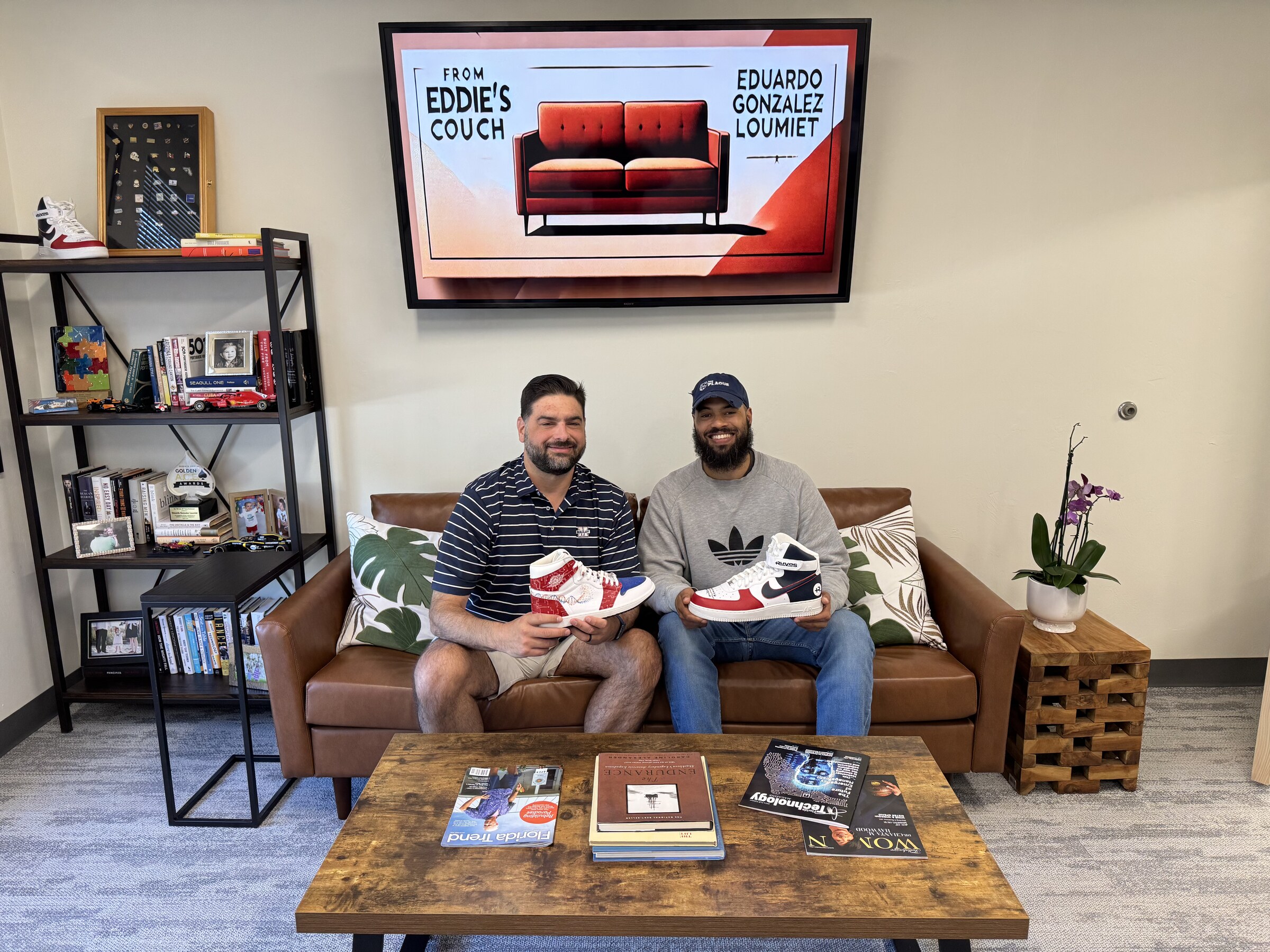 Eddie Gonzalez Loumiet sitting with a visitor on the couch in his office